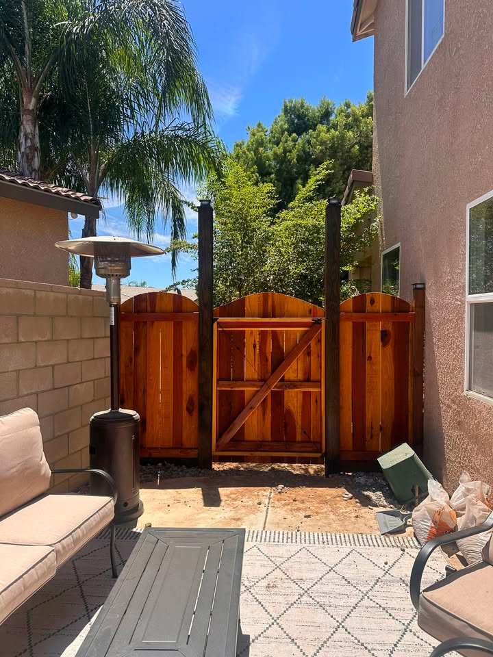 Same wood fence and gate seen from the backyard patio