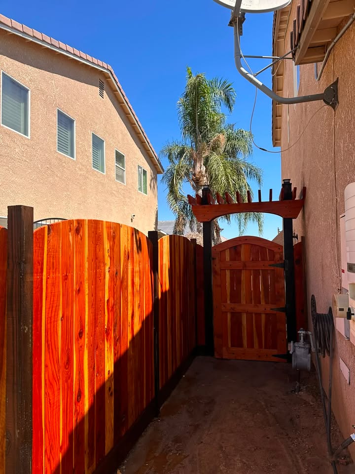 Wood fence and gate from a second backyard angle